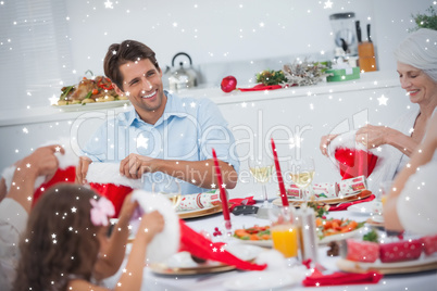 Composite image of cheerful family dining together