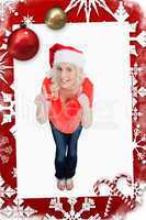 Fairhaired woman putting her thumbs up while wearing christmas c