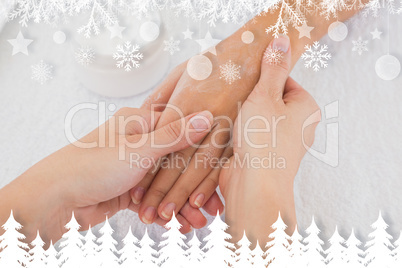 Composite image of hands applying cream