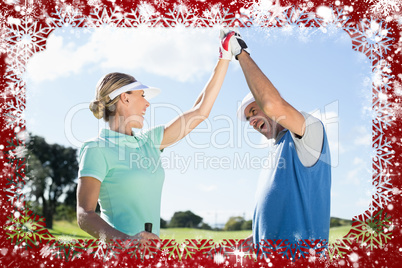 Golfing couple high fiving on the golf course