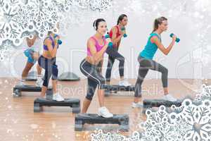Fitness class performing step aerobics exercise with dumbbells