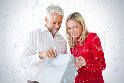 Smiling couple looking into shopping bag