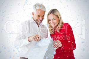 Smiling couple looking into shopping bag