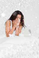 Brunette woman having a cold sitting in bed