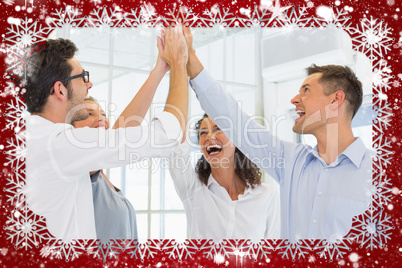 Composite image of casual business team high fiving