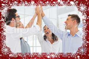 Composite image of casual business team high fiving