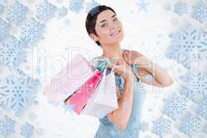 Darkhaired woman posing with shopping bags