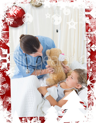Doctor with teddy bear entertaining sick girl