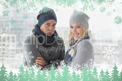 Cute couple in warm clothing smiling at camera