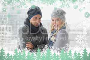 Cute couple in warm clothing smiling at camera