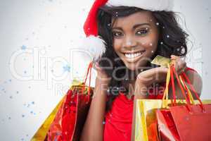 Festive woman standing looking while holding bags