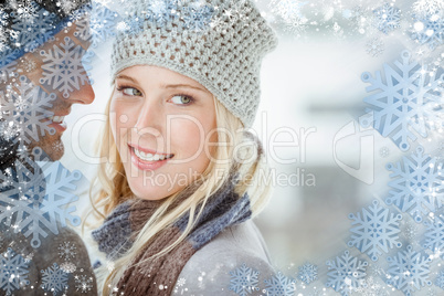 Composite image of couple in warm clothing hugging