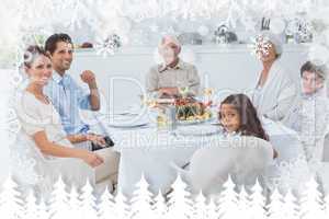 Composite image of family smiling at the dinner table