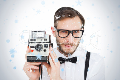 Geeky hipster holding a retro camera