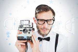 Geeky hipster holding a retro camera