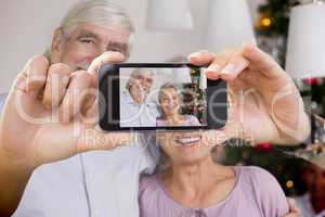 Composite image of hand holding smartphone showing