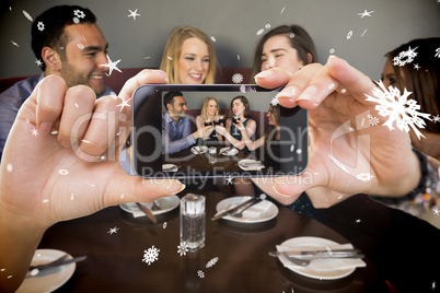 Hand holding smartphone showing photo