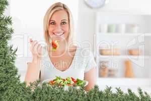 Close up of a gorgeous woman eating salad