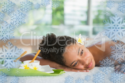 Gorgeous woman lying on massage table with salt treatment on back
