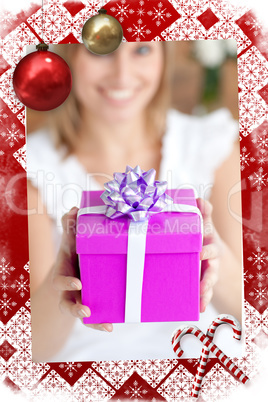 Young woman holding a present sitting on the floor
