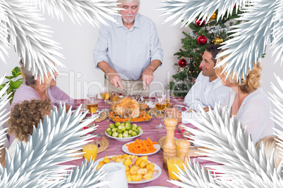 Composite image of grandfather carving the turkey