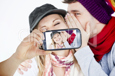 Composite image of hand holding smartphone showing