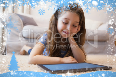 Close up of a little girl using digital tablet in living room