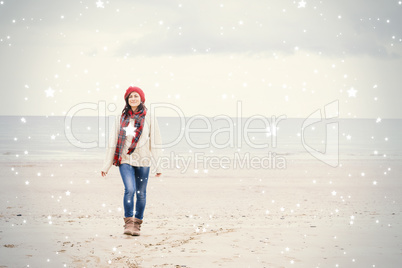 Pretty woman in stylish warm clothing at beach