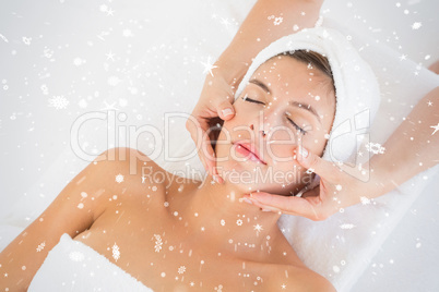 Attractive woman receiving facial massage at spa center