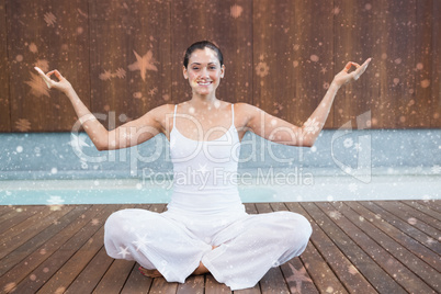 Peaceful happy woman in white sitting in lotus pose