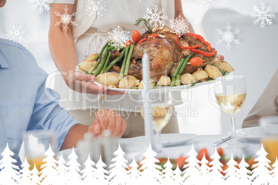 Composite image of woman brining a roast chicken in the dining r