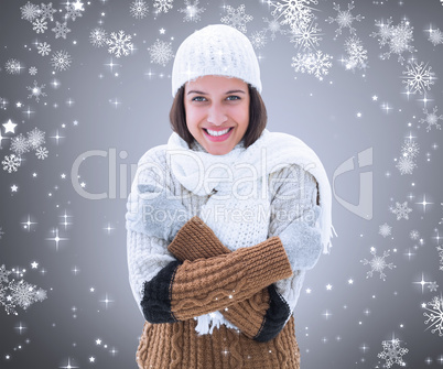 Composite image of brunette in warm clothing