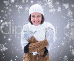 Composite image of brunette in warm clothing