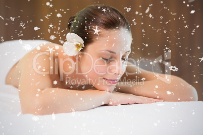 Beautiful woman lying on massage table at spa center