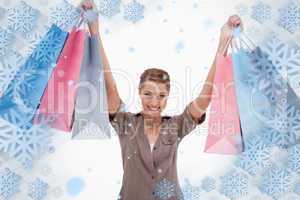 Smiling woman raising her shopping bags
