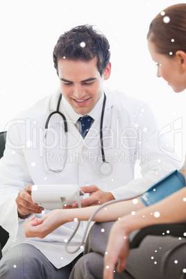 Doctor taking blood pressure of a patient