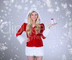 Composite image of pretty girl in santa outfit holding gift