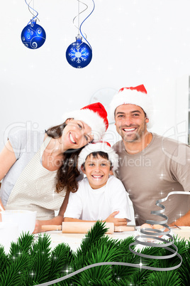 Composite image of happy family baking christmas cookies togethe