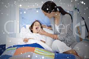 Composite image of mother taking her sons temperature with a the