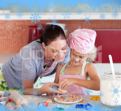 Pretty mother and her daughter baking in a kitchen