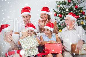 Composite image of little girl opening christmas present