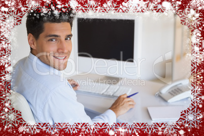 Casual businessman at desk smiling at camera