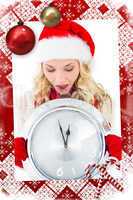 Composite image of festive blonde holding large clock