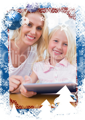 Mother using tablet pc with her daughter