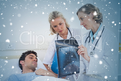 Composite image of doctors showing radiography to a patient