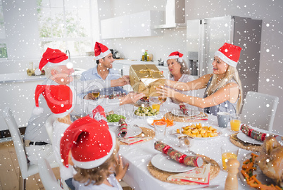 Composite image of festive family exchanging gifts