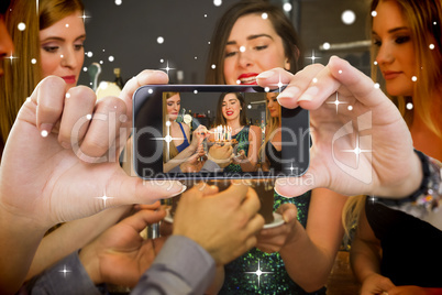 Hand holding smartphone showing photo