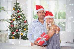 Composite image of happy couple at christmas