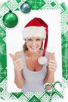 Portrait of a woman with the thumbs up and a christmas hat