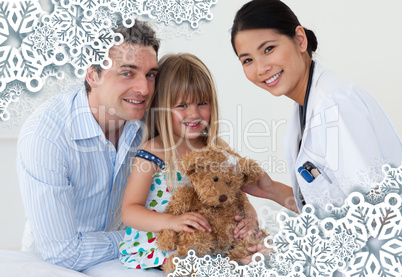 Portrait of a doctor and happy little girl examing a teddy bear